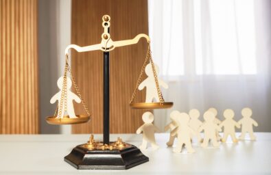 On the judge's scales, there are figures of people in each bowl, with a waiting line or other figures of people watching below. Social justice, comparison, inequality, court, public condemnation, dispute resolution