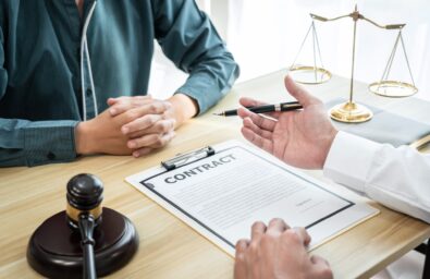 Male lawyer is meeting with businessman client to discuss consultation with litigation contract papers document of estate working in a workplace (Male lawyer is meeting with businessman client to discuss consultation with litigation contract papers do